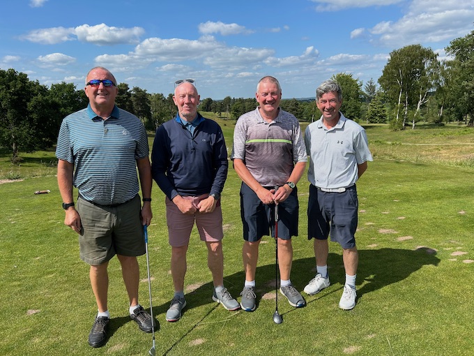 A four-ball on the tee with the heathland behind