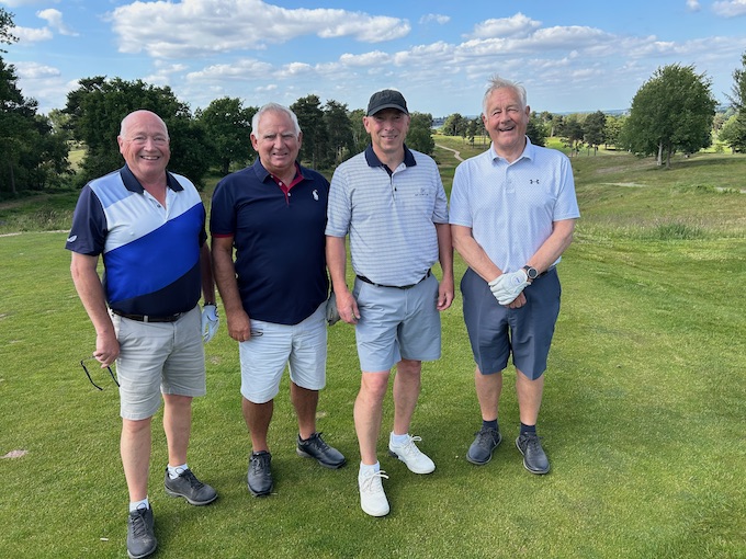 Members on the tee with the course rolling away behind