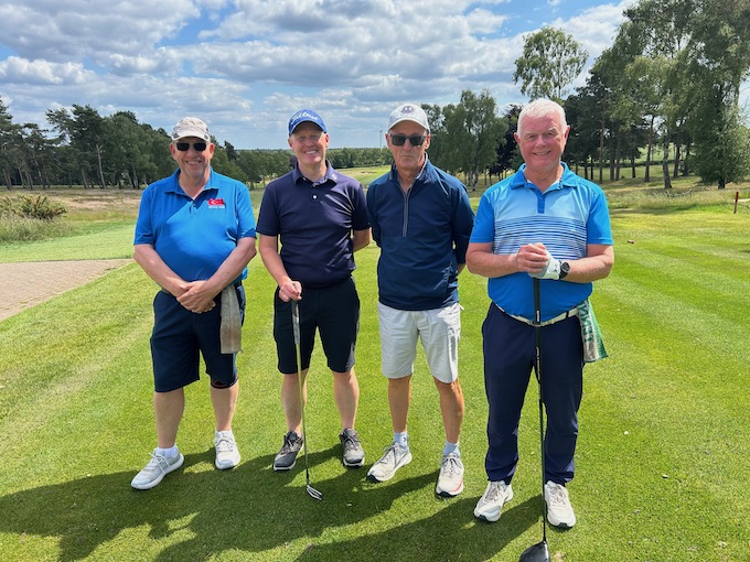 A group on the tee beside the silver birches