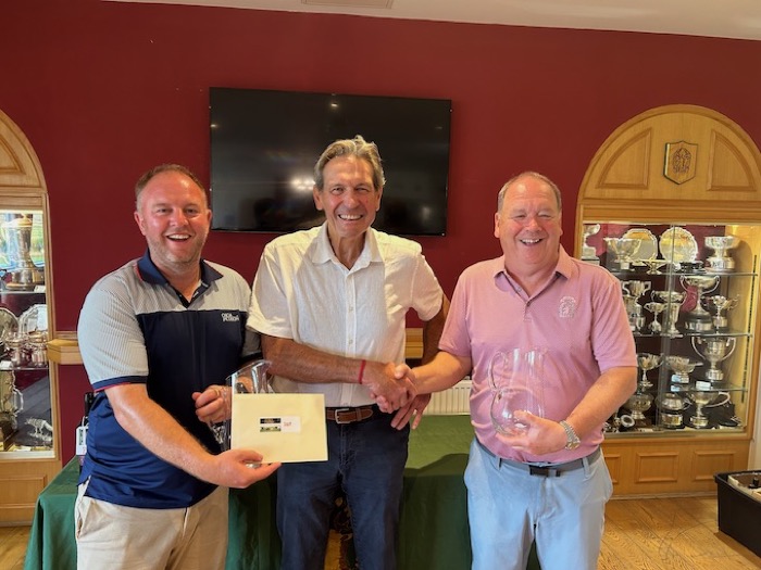 Tony presenting prizes to two members in the clubhouse